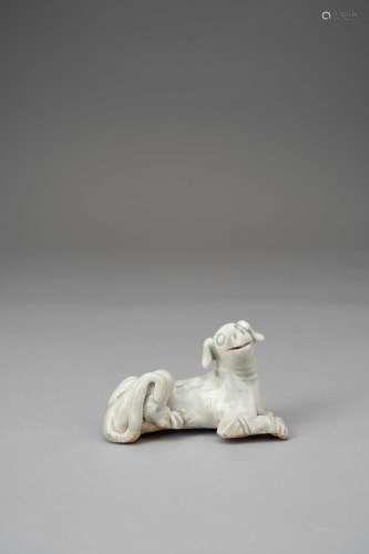 A CHINESE CELADON GLAZED MODEL OF A DOGPROBABLY SONG DYNASTY...