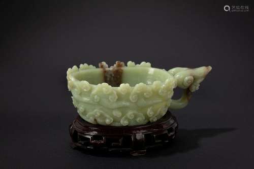 A green jade and russet carving. China, 20th c.