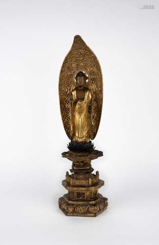 A carved wood standing Buddha. Japan, late 19th c.