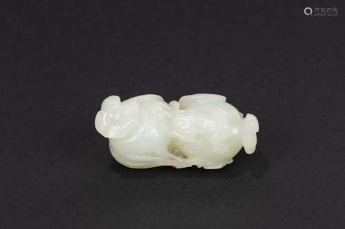 A white jade carving of two peaches with a frog. China, late...