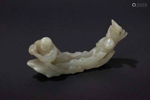 A celadon jade carving of a boot. China, half of 19th c.