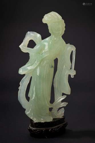 A green jade carving of a lady with a fan