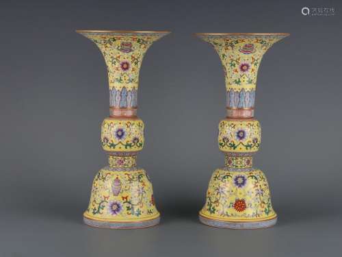 A pair of yellow-ground famille rose goblets with entangling...
