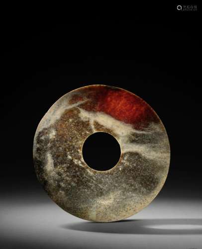 A LARGE BUFF AND ALTERED RED JADE DISC, BI Northwest China, ...
