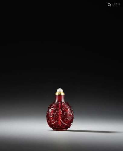 AN IMPERIAL CARVED RED GLASS 'DRAGON' SNUFF BOTTLE I...