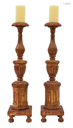 A PAIR OF ITALIAN GILTWOOD AND POLYCHROME PRICKET CANDLESTIC...