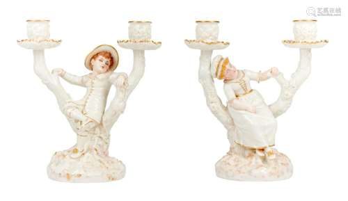 A PAIR OF ROYAL WORCESTER PORCELAIN TWO-LIGHT CANDLESTICKS M...