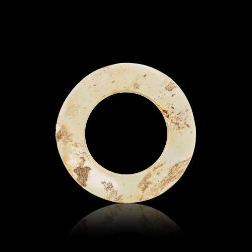 An archaic calcified jade ring, yuan, Neolithic period, Lian...