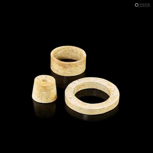 A group of three archaic calcified jade cylindrical ornament...
