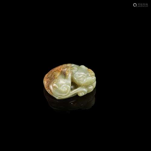 A celadon and russet jade recumbent mythical beast, 17th cen...