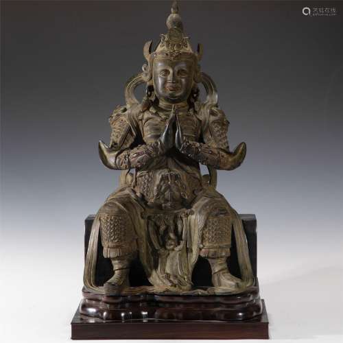 A CHINESE BRONZE SEATED GUARDIAN