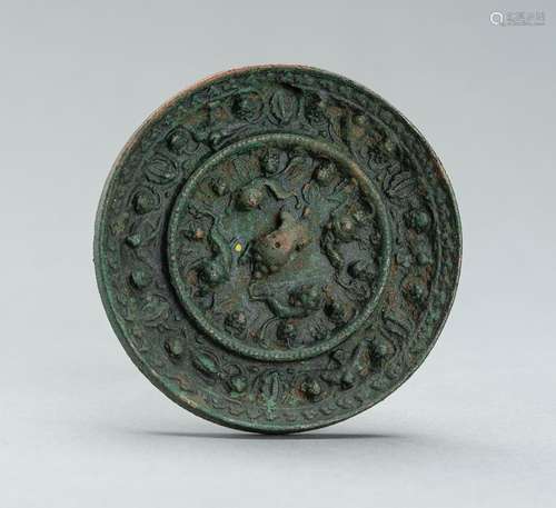 A TANG DYNASTY BRONZE ‘LION AND GRAPEVINE’ MIRROR