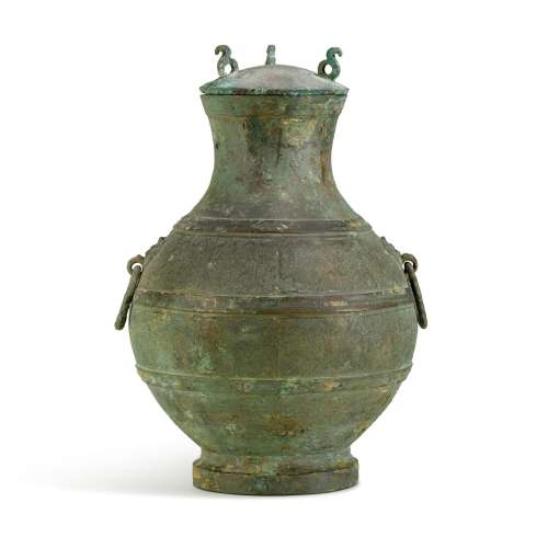 <br />
An archaic copper-inlaid bronze wine vessel, hu, East...