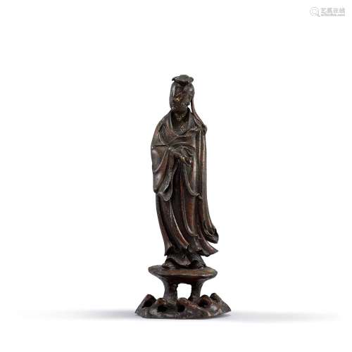 <br />
A parcel-gilt bronze figure of a Daoist immortal, Min...