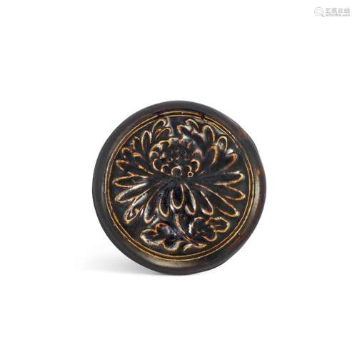 <br />
A black-glazed circular 'chrysanthemum' box and cover...