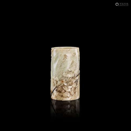 <br />
A small calcified jade 'prunus' cylindrical brushpot,...