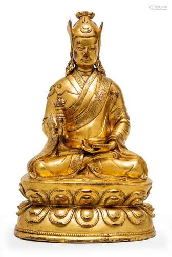 A FINE TIBETAN GILT BRONZE SEATED PADMASAMBHAVA, 15TH/16TH C...