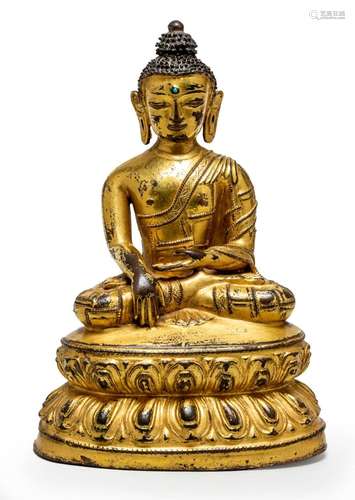 A FINE AND RARE TIBETAN GILT-BRONZE SEATED FIGURE OF A BUDDH...