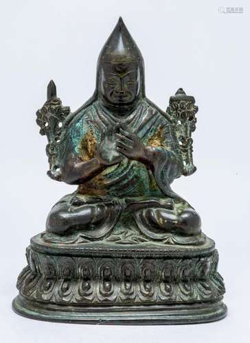 A TIBETAN BRONZE FIGURE OF A GELUGPA LAMA, POSSIBLY TZONGKHA...