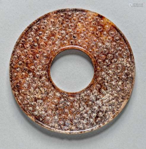 A CHINESE MOTTLED RUSSET JADE DISC BI, WARRING STATE/HAN DYN...