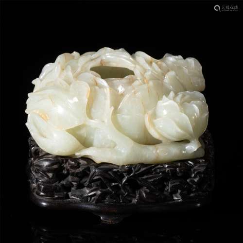 A CHINESE CARVED JADE FLORAL DECORATION AND WOOD STAND