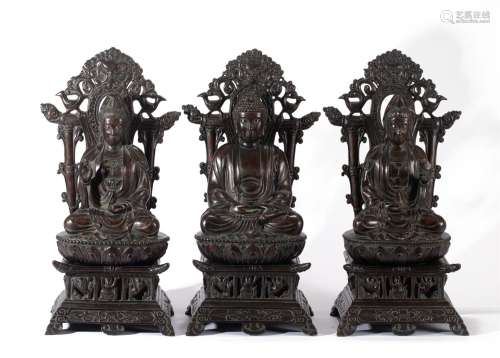 A GROUP OF THREE CARVED ALOESWOOD BUDDHAS