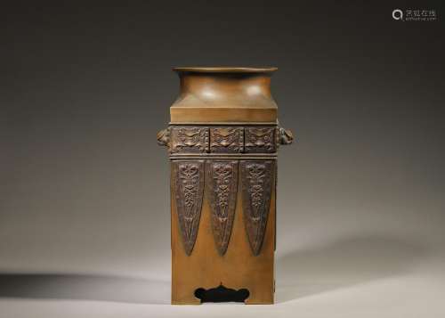 A taotie and banana leaf patterned copper vase with beast sh...