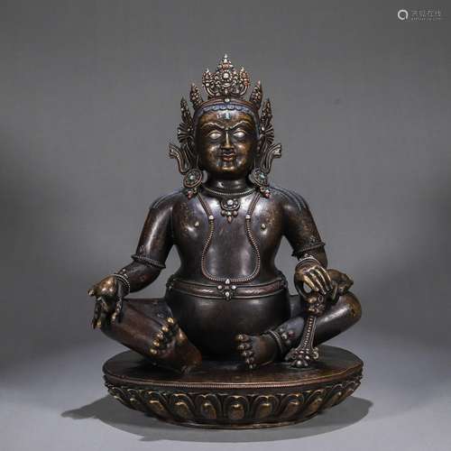 A gem and silver-inlaid copper yellow Jambhala statue