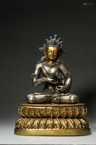 A gem-inlaid silver buddha statue