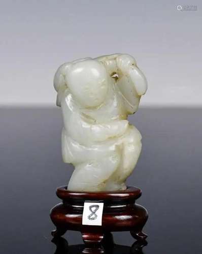 A White Jade Carved Lotus Boy with Stand Qing