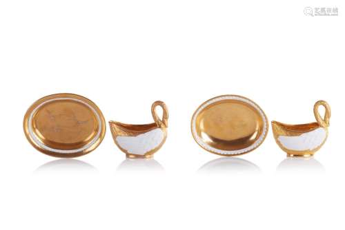 A set of two swan shaped cups with saucers