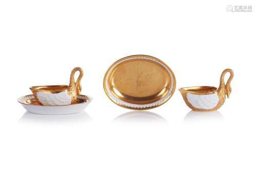 A set of two swan shaped cups with saucers