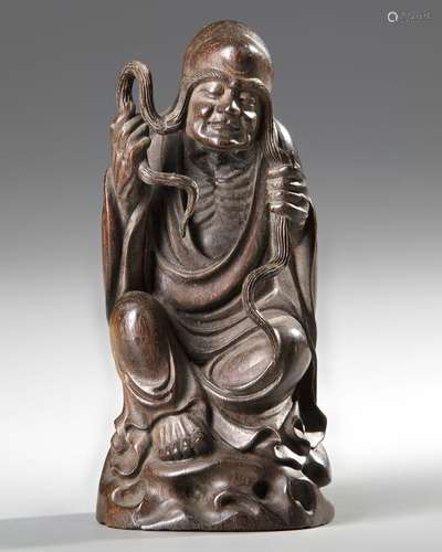 A CHINESE WOOD CARVING OF A LOHAN,20TH CENTURY