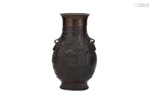 A bronze vase with two rings and relief decor of dr