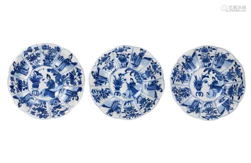 A set of three blue and white deep dishes with lobe