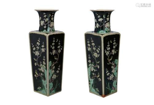 A pair of famille noir porcelain vases, decorated w