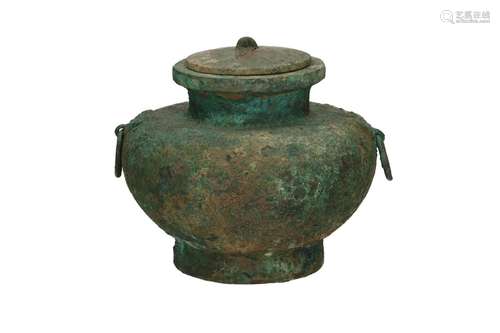 A bronze lidded jar with grips in the shape of ring