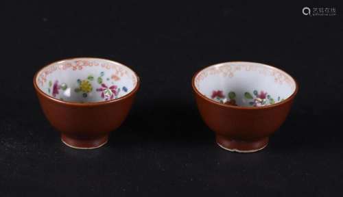 Two porcelain Famille Rose cups with a capuchin exterior and...