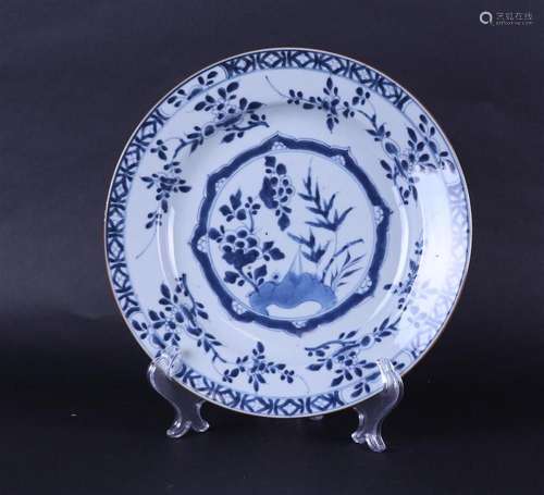 A porcelain dish with floral decoration in the center and wi...