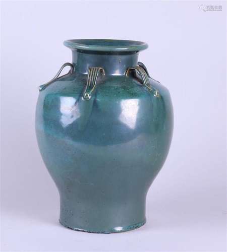 A green-glazed earthenware vase. China, 20th century.