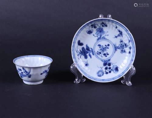 A ribbed porcelain cup and saucer with floral decor. China, ...