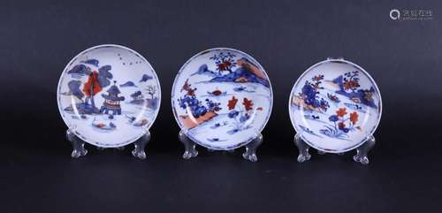 Three porcelain Imari plates with decoration of a riverlands...