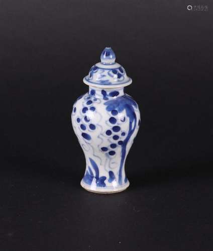 A porcelain lidded vase with floral decoration  and grapes i...
