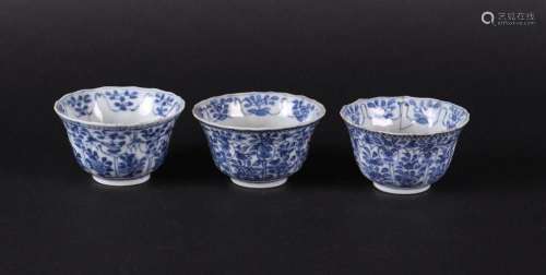 Three porcelain bowls with floral decoration on the outside,