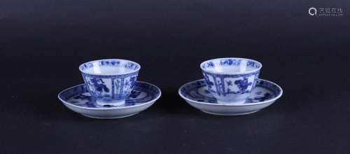 Two porcelain cups and saucers with compartments, and a play...