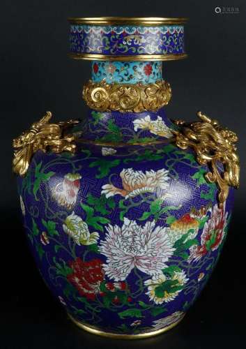A large cloisonné vase decorated with flowers and on the sid...