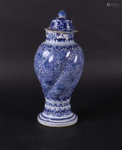 A porcelain lidded vase with twisted relief decoration in wh...
