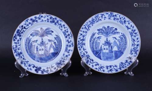 Two porcelain plates with a decoration of a house in a lands...