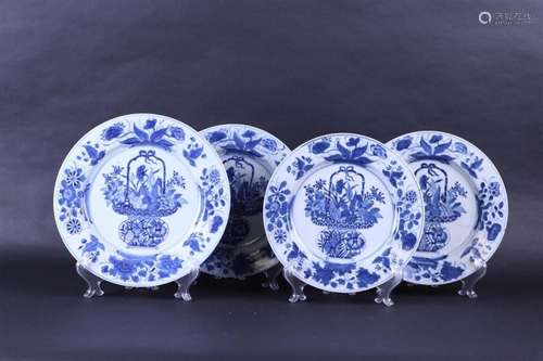 A lot of four porcelain plates decorated with a floral baske...