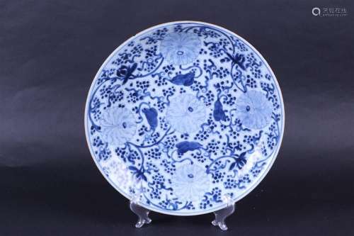 A large porcelain dish decorated with chrysanthemums and gra...